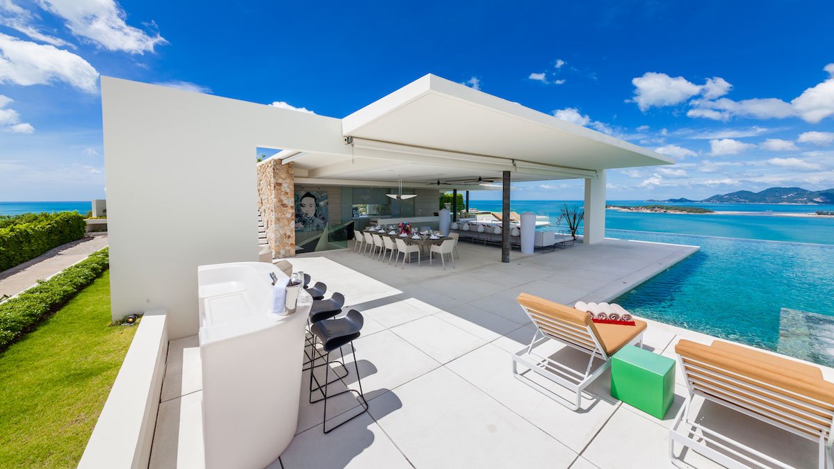 a beautiful white home villa near an ocean showing the concept of best villas with ocean views.